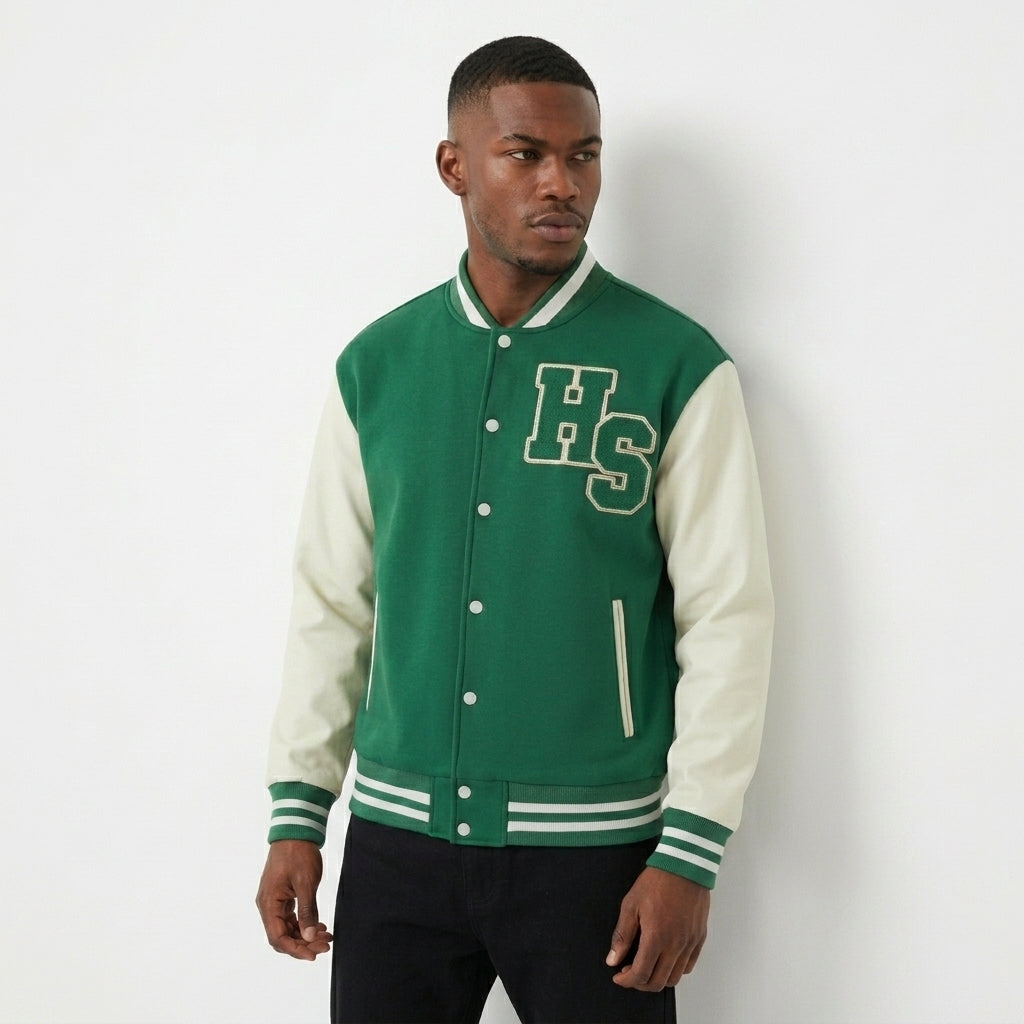 Green and cream Two-Tone Fleeced Varsity Jacket worn with black pants in an angled front view.