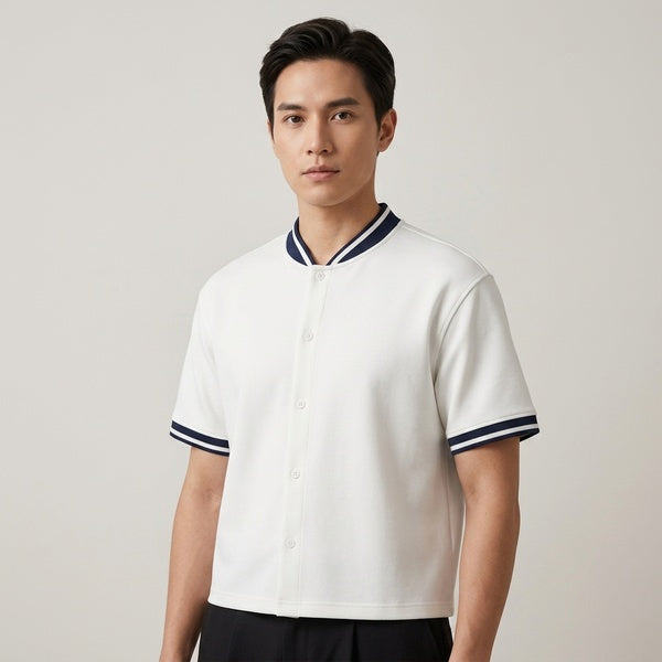 White oversized baseball jersey with a button front and navy striped trim, three-quarter front view.