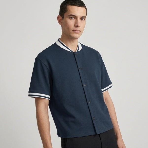 Navy oversized baseball jersey with short sleeves, three-quarter front view on a model.