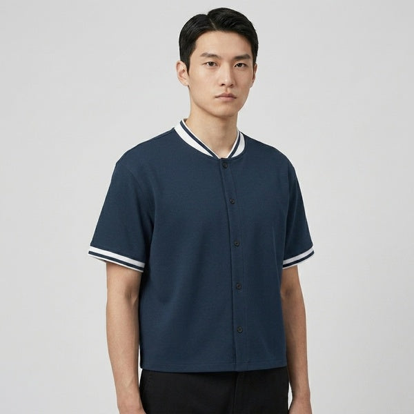 Navy oversized baseball jersey with a button front and white striped collar and cuffs, front view.