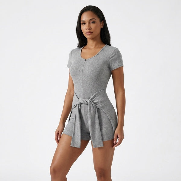 Gray short-sleeve tie-waist romper with a scoop neckline and cape panel tied at the front, three-quarter view.
