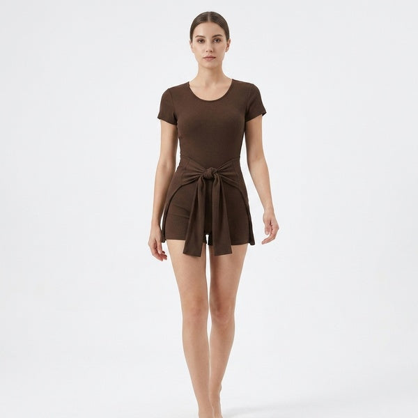 Brown short-sleeve tie-waist romper with the cape panel tied at the front, full-length front view.