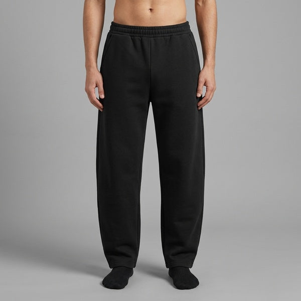 Black unisex barrel leg sweatpants with an elastic waist and relaxed legs, front product view on a model.