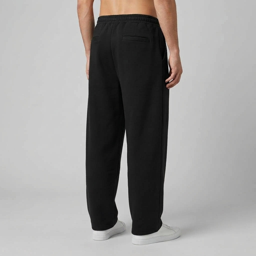 Back of the black barrel leg sweatpants showing the elastic waist and relaxed leg shape.