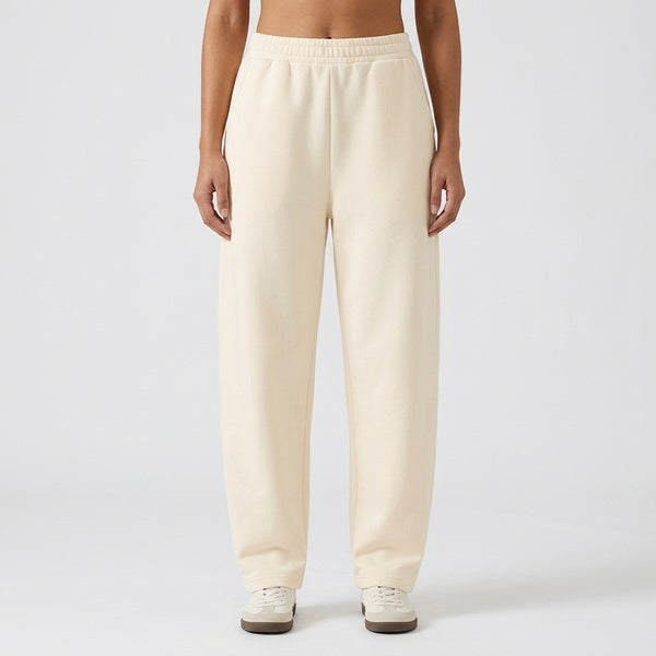 Cream unisex barrel leg sweatpants with an elastic waist and relaxed legs, front view.