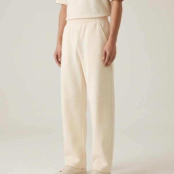 Cream barrel leg sweatpants, side view showing the pocket and loose leg shape.