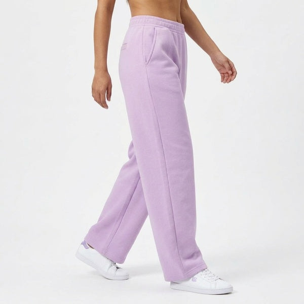 Lavender barrel leg sweatpants styled with white sneakers, side view on a model walking.