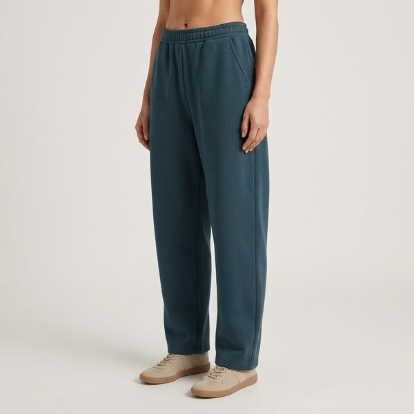 Dark teal barrel leg sweatpants, three-quarter view showing the elastic waist and roomy legs.