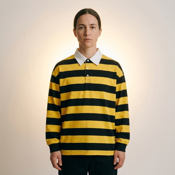Yellow and navy striped long-sleeve polo shirt with dropped shoulders, front view on a model.