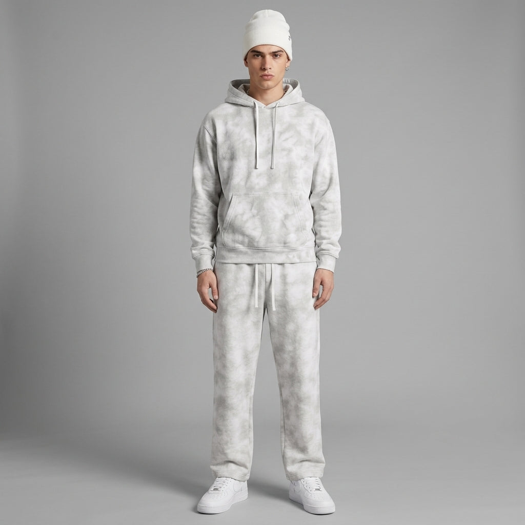 Light gray dirty-washed fleece sweatpants styled with a washed hoodie and white sneakers.