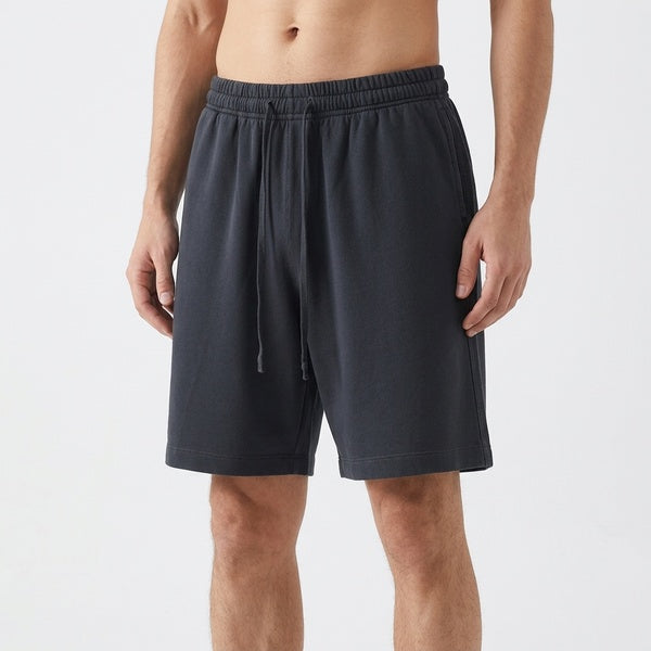 Black vintage wash cotton shorts with an elastic waistband and drawstring, close front view on a model.