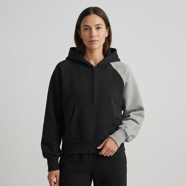 Black and gray Unisex Color-Block Fleece Hoodie worn with the hood down, showing the quarter-zip front.