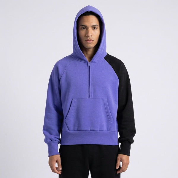 Front view of the purple and black Unisex Color-Block Fleece Hoodie worn with the hood up.