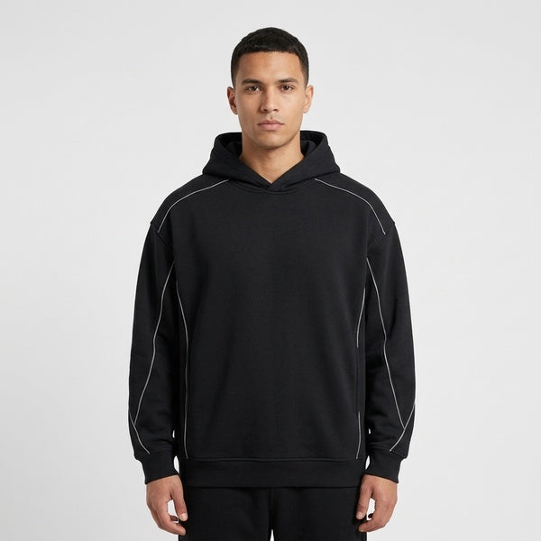Front view of the black Unisex Oversized Piping Fleece Hoodie worn with the hood down.