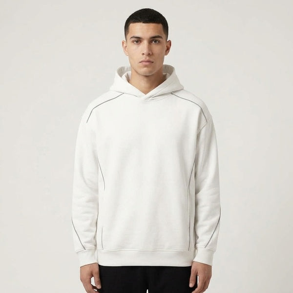 Front view of the white Unisex Oversized Piping Fleece Hoodie worn with black pants.