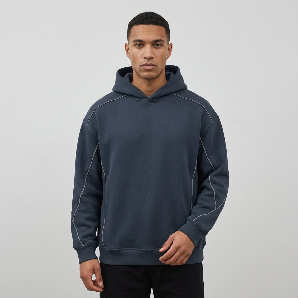 Navy oversized piping fleece hoodie, model in a three-quarter front view.