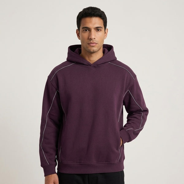 Purple oversized piping fleece hoodie, model in a three-quarter front view with the hood down.