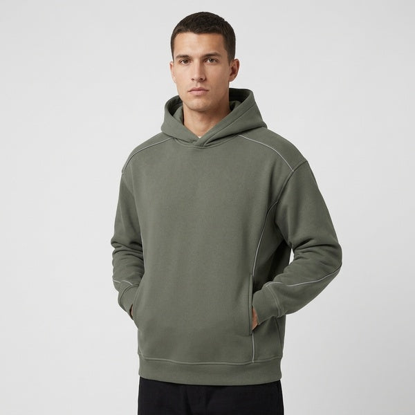 Muted gray-green oversized piping fleece hoodie, model in a three-quarter front view.