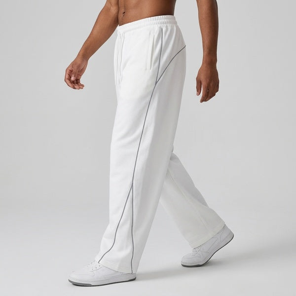 White piping fleece barrel-leg sweatpants, model walking in a side view.