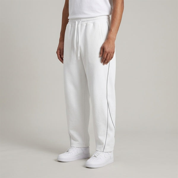 White piping fleece barrel-leg sweatpants, model in a three-quarter front view.