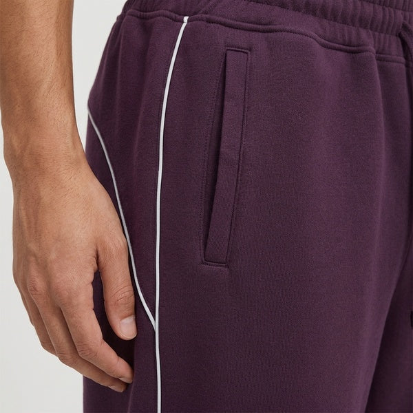 Purple piping fleece sweatpants, close-up of the side pocket and piping.