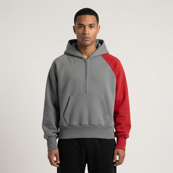 Gray and red color-block fleece hoodie, model in a front view with the hood down.