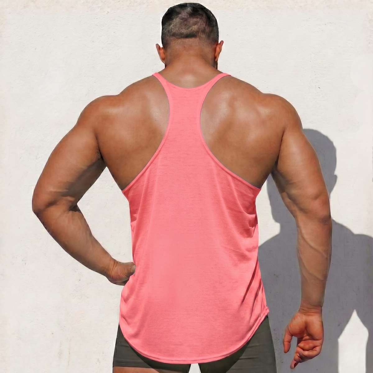 Coral Stringer Tank Top, model in a back view, showing the racerback cut.