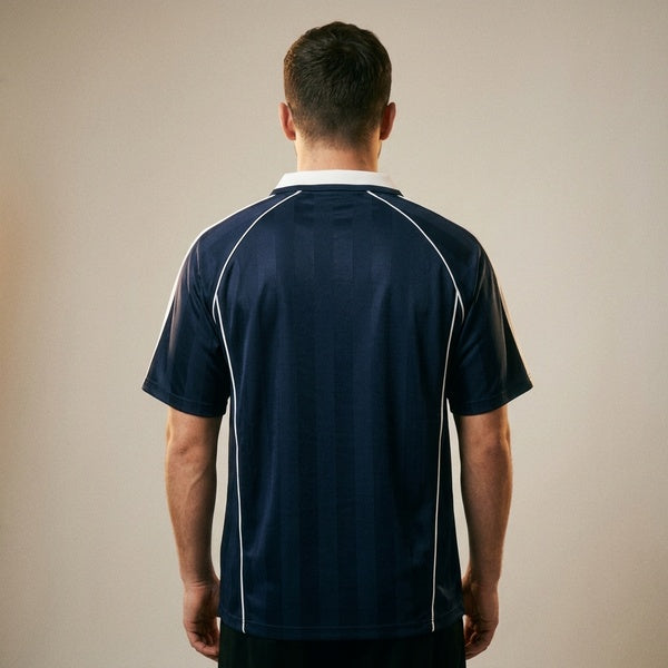 Back of the navy shadow-stripe soccer jersey showing the white seam piping.