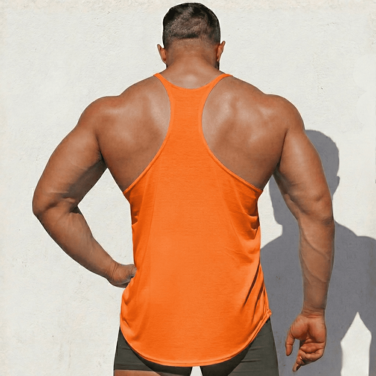 Orange Stringer Tank Top, model in a back view, showing the racerback cut.