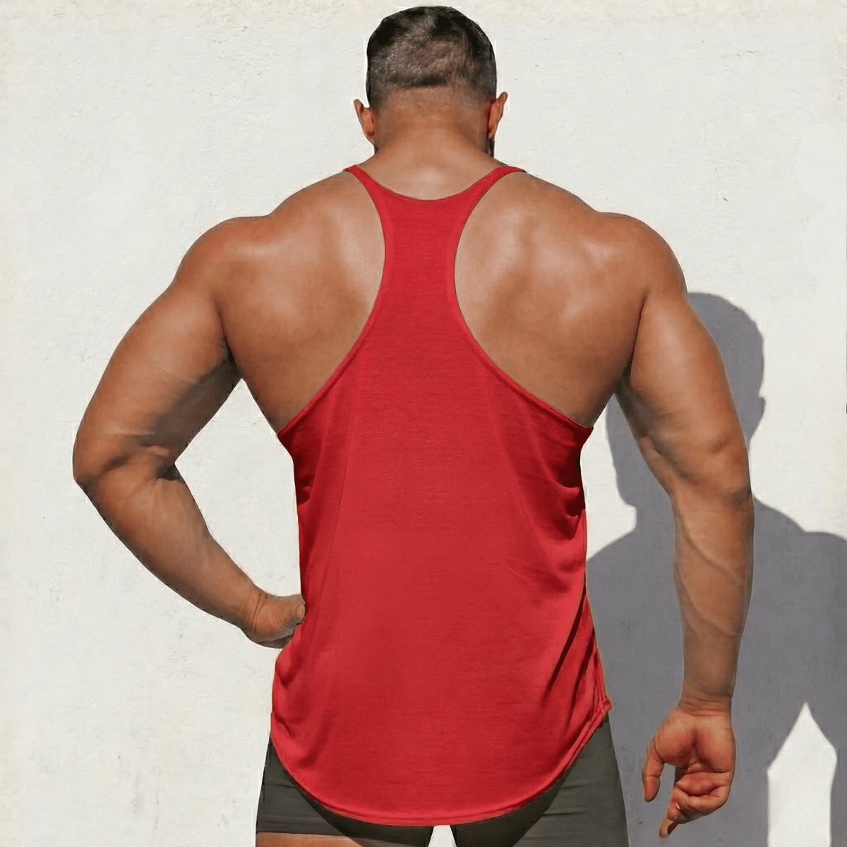 Red Stringer Tank Top, model in a back view, showing the racerback cut.