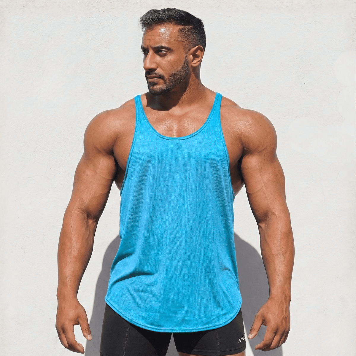 Turquoise Stringer Tank Top, model in a front view.