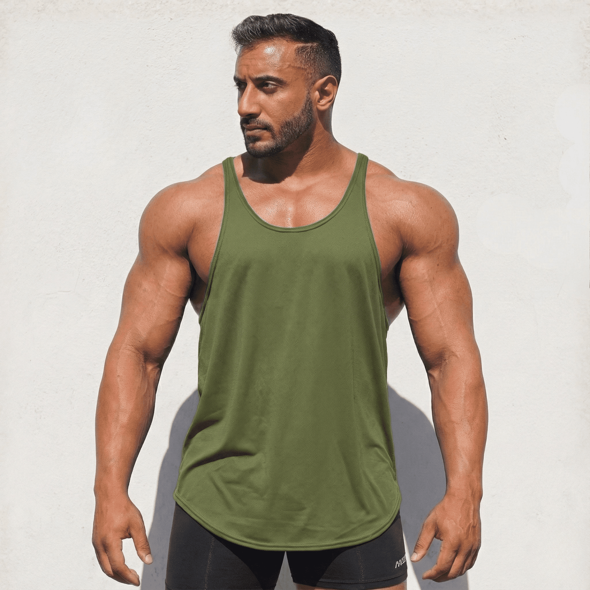 Muted gray-green Stringer Tank Top, model in a front view.