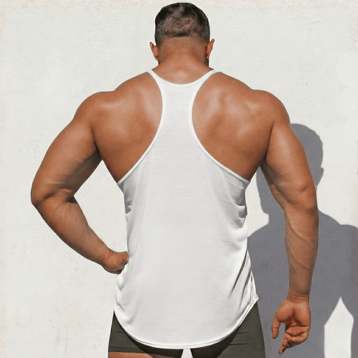 White Stringer Tank Top, model in a back view, showing the racerback cut.