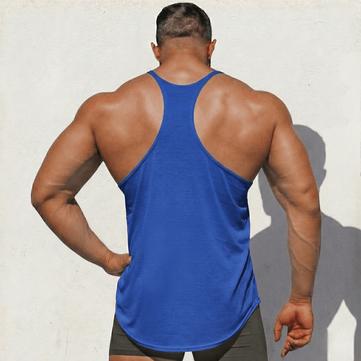 Blue Stringer Tank Top, model in a back view, showing the racerback cut.