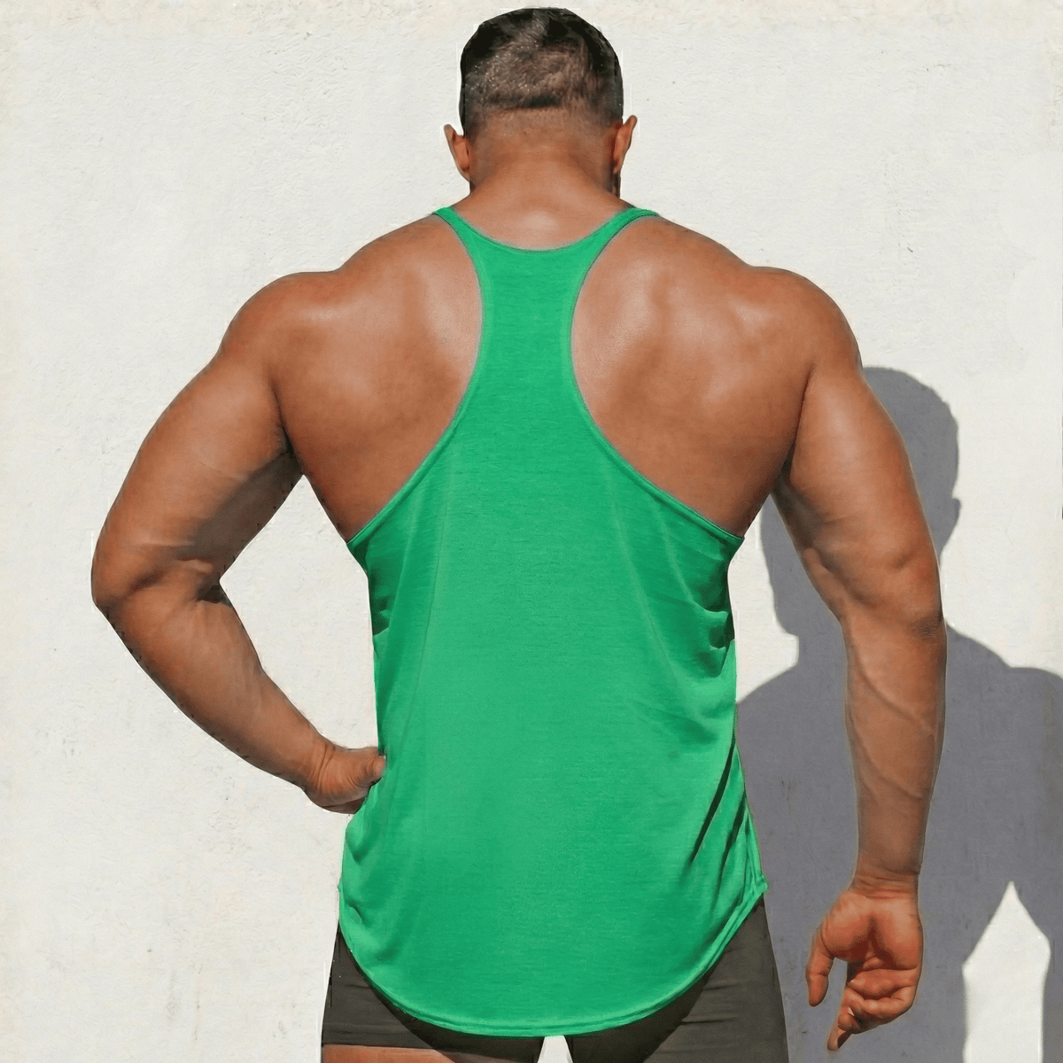 Green Stringer Tank Top, model in a back view, showing the racerback cut.