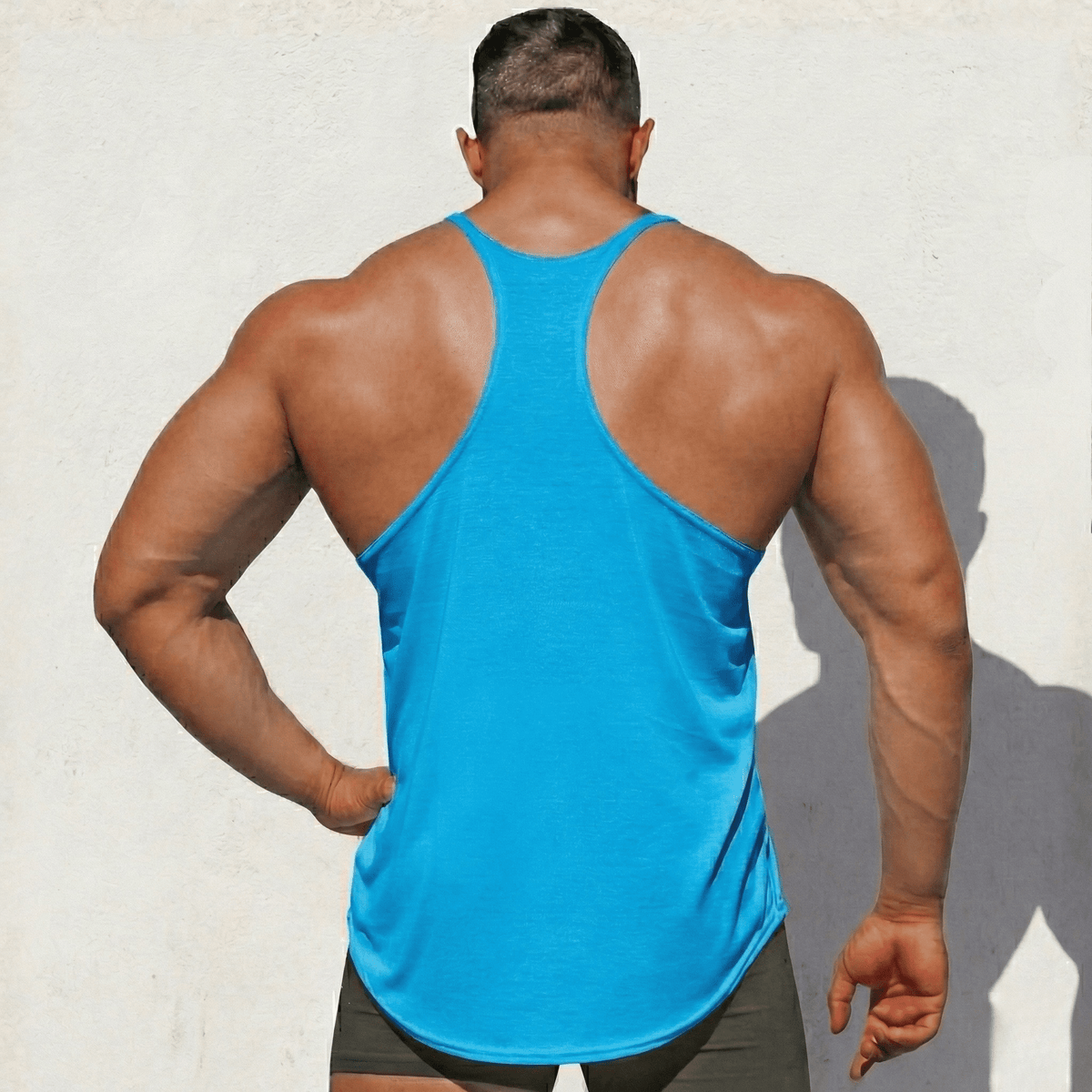Turquoise Stringer Tank Top, model in a back view, showing the racerback cut.