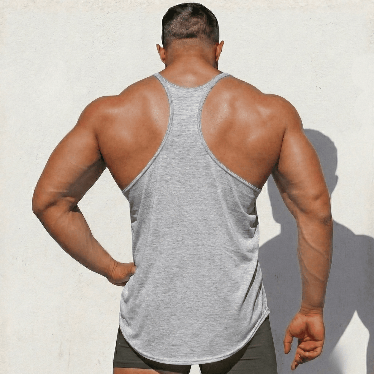 Heather gray Stringer Tank Top, model in a back view, showing the racerback cut.