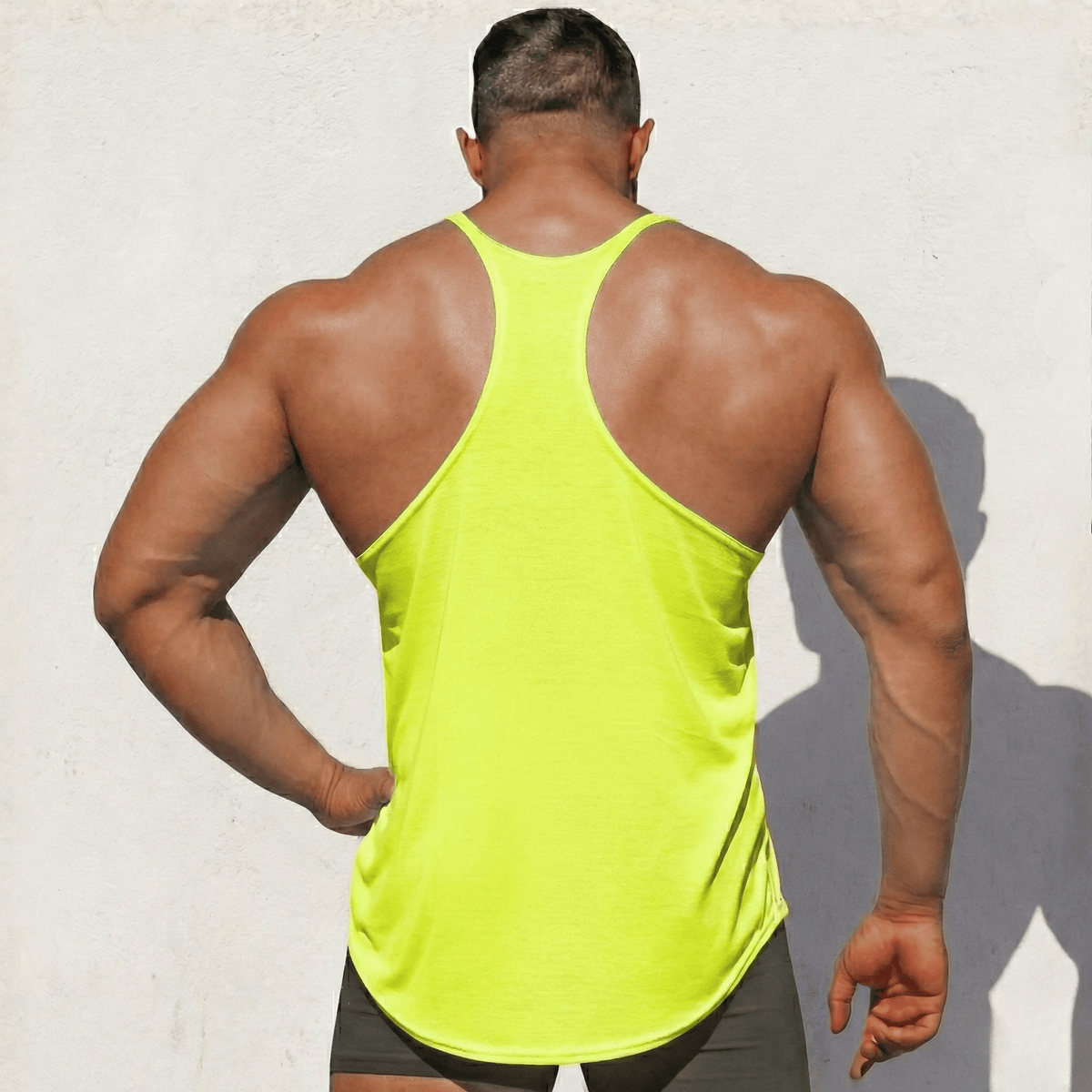 Neon yellow Stringer Tank Top, model in a back view, showing the racerback cut.